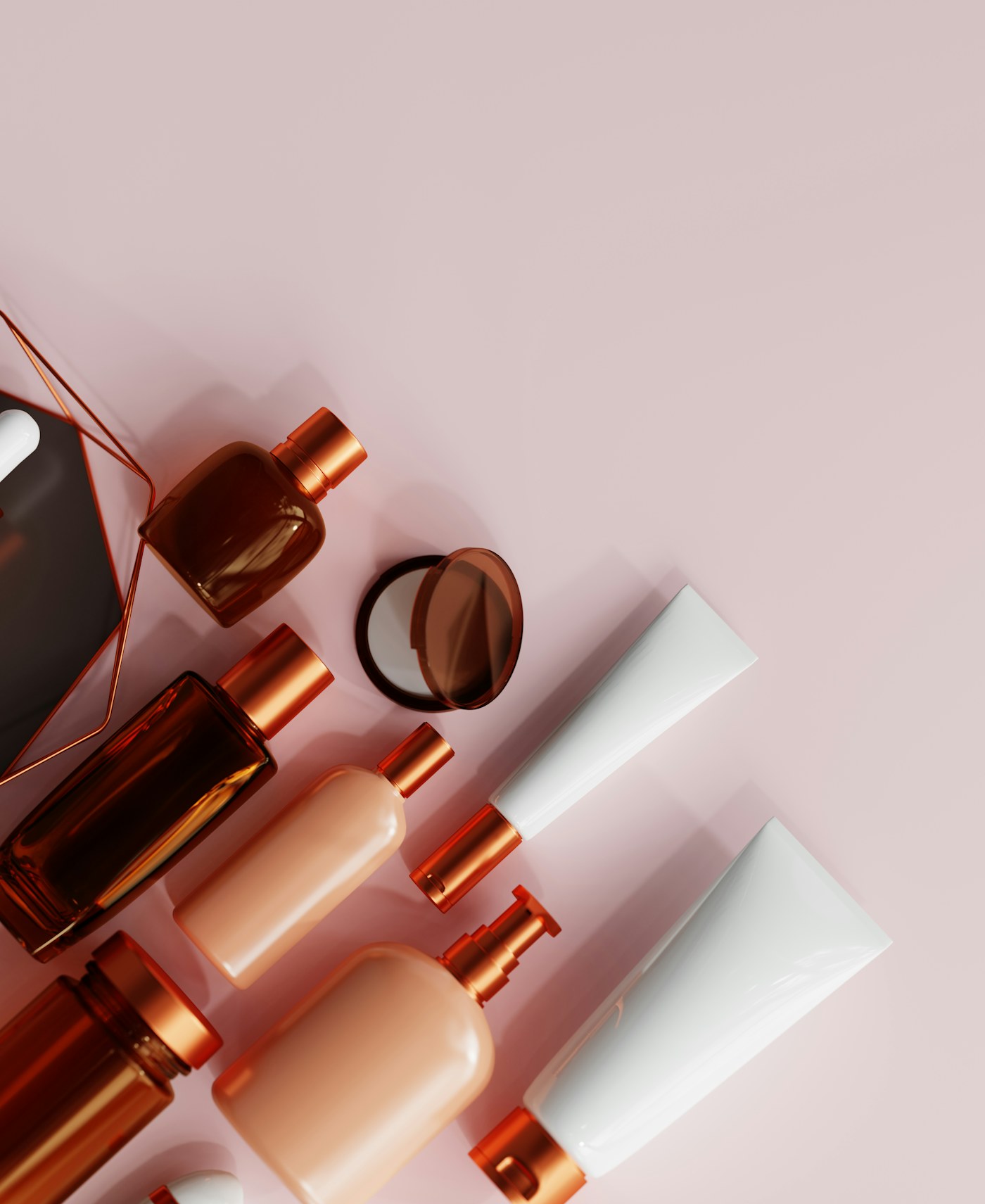 Assortment of makeup products on a pink background